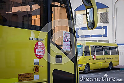 Yellow school bus in Abu Dhabi, United Arab Emirates, Dubai, Emirates, Gulf, Middle east. Awareness signs and symbol was written Editorial Stock Photo