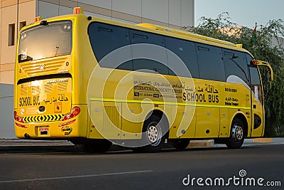 Yellow school bus in Abu Dhabi, United Arab Emirates, Dubai, Emirates, Gulf, Middle east. Awareness signs and symbol was written Editorial Stock Photo