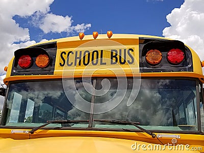 Yellow school bus with cloud reflection Stock Photo