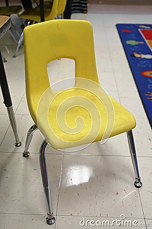 Yellow School Chair in education elementary classroom Stock Photo