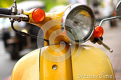 Yellow scooter on street Stock Photo