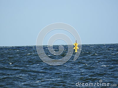 Yellow Sea water windmill blue sky Stock Photo