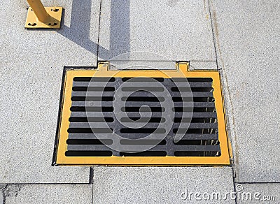 Yellow sewer cover Stock Photo