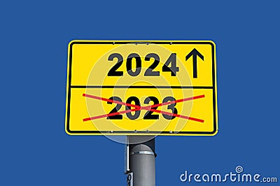 Yellow sign with black lettering. Below the word 2023 crossed out in red and above it the word 2024 Stock Photo