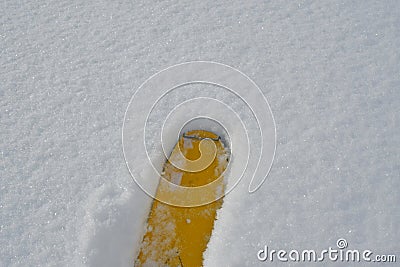 yellow ski tip in fresh powder snow background Stock Photo