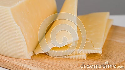 Yellow sliced cheese on wooden board Stock Photo
