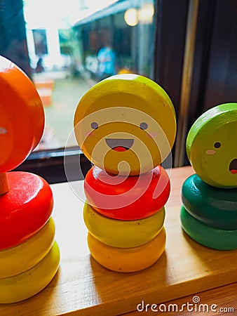 Yellow Smiley wooden logic toy for Kids Stock Photo