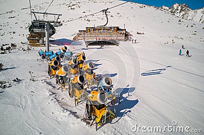 Yellow snow cannons on slope Editorial Stock Photo