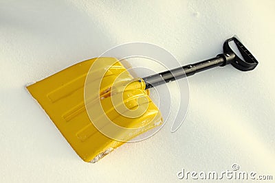 Yellow snow shovel Stock Photo