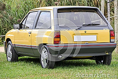 Yellow sports car Opel Corsa 1.3 SR standing on the green grass Editorial Stock Photo