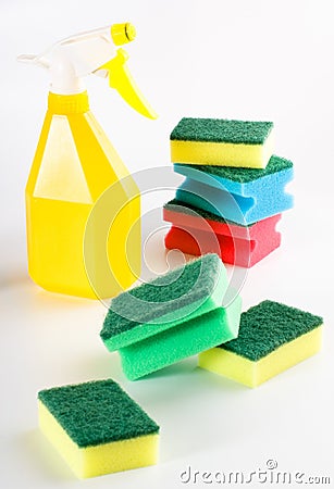 Yellow spray bottle and multicolored sponges Stock Photo