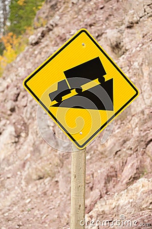 Yellow Square Road Sign Warning Steep Decline Ahead Stock Photo