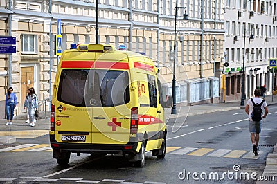 Yellow State Ambulance quickly moves to help the patient Editorial Stock Photo