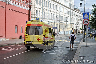 Yellow State Ambulance quickly moves to help the patient Editorial Stock Photo