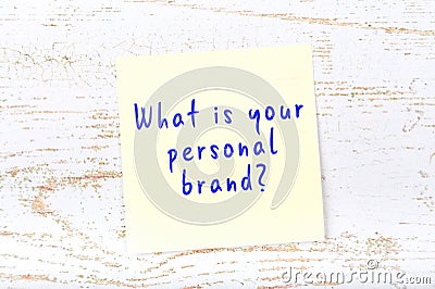 Yellow sticky note with handwritten text what is your personal brand Stock Photo