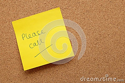 Yellow sticky note - Please Call - on cork board Stock Photo