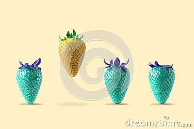 Yellow strawberry floating with blue strawberry on bright background. Minimal food concept Stock Photo
