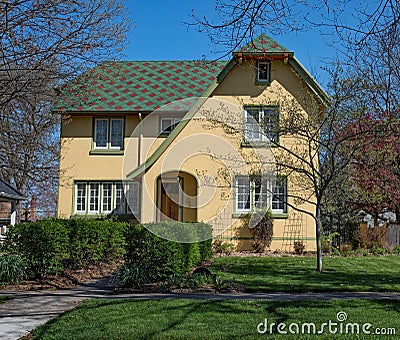 Yellow Stucco House with Patchwork Roof Stock Photo