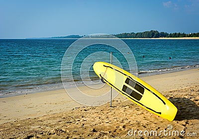 Yellow surf rescue surfboard on the beach Stock Photo