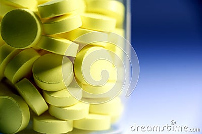Yellow Tablets in Glass Bottle Stock Photo