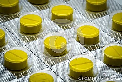 Yellow tablets pill in blister pack. Full frame of tablet pills Stock Photo