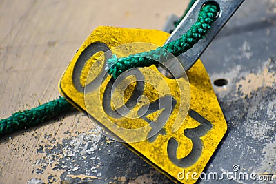 Yellow Tag 0043 with Turquoise Rope Stock Photo