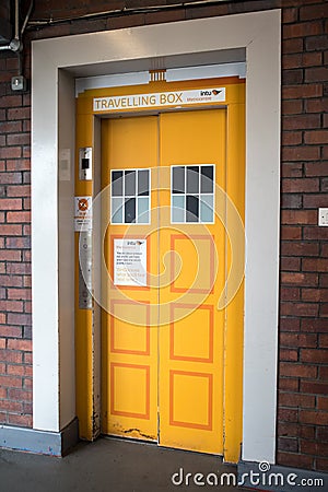 Yellow Tardis style graphic art on the doors to an elevator lift Editorial Stock Photo