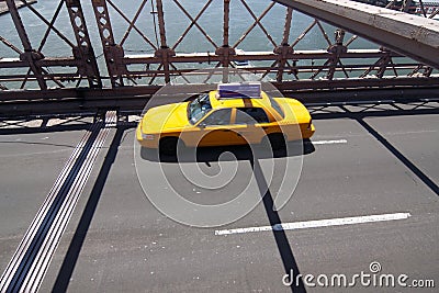 Yellow taxi on Brooklyn bridge Stock Photo
