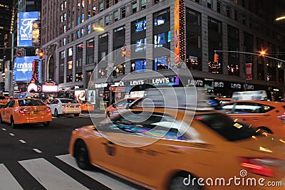 Yellow taxi cars in New York City at night Editorial Stock Photo