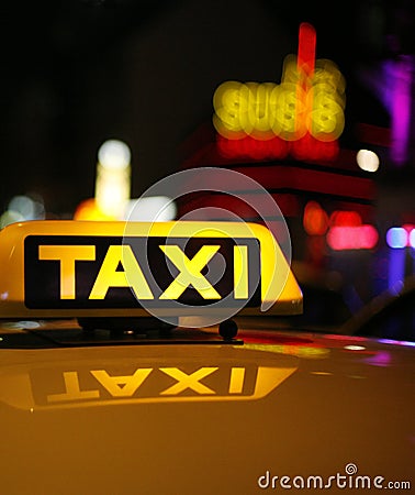 Yellow taxi sign on car roof Stock Photo