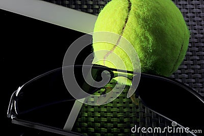 Creative Set Tennis ball, tablet computer and black sunglasses, close-up, on metal background. Stock Photo