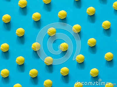 Yellow tennis ball patter on blue Stock Photo