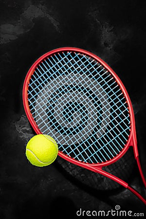 Yellow tennis ball with red racket on a black background Stock Photo