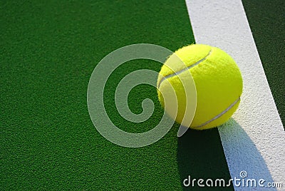 Yellow Tennis Ball on White Side Line Stock Photo