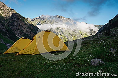 Yellow tents at Mulling campsite in Pin Bhaba pass trek in Shimla, Himalaya mountain range in north India Stock Photo