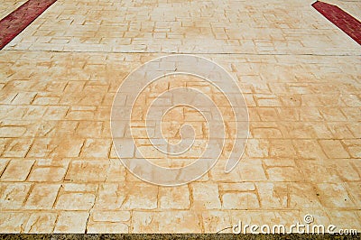 Yellow texture of an old ancient brick tile with seams on the floor with brown strips. Stock Photo