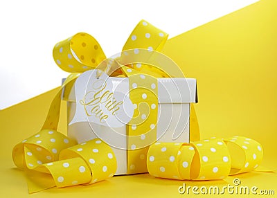 Yellow theme gift box with yellow polka dot ribbon and white copy space Stock Photo