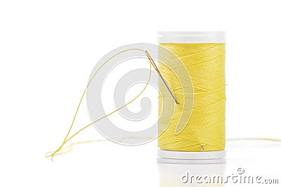 Yellow thread and one needle. Stock Photo