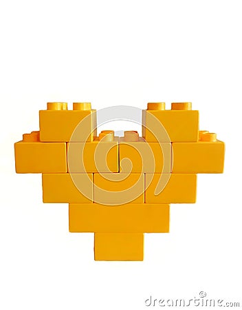 Yellow toy bricks heart on white background Stock Photo