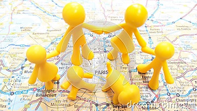 A yellow toy family holding hands exploring Paris Stock Photo