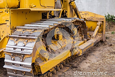 Yellow Tractor on crawler track. Close-up of crawler bulldozer truck. Earthmoving heavy machinery Stock Photo