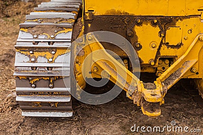 Yellow Tractor on crawler track. Close-up of crawler bulldozer truck. Earthmoving heavy machinery Stock Photo