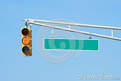 Yellow traffic signal light with sign Stock Photo