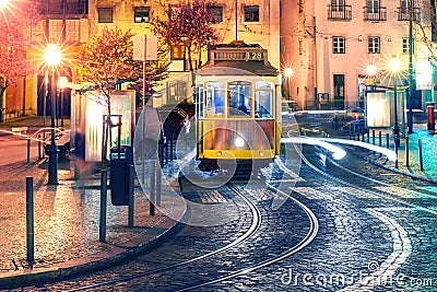 Yellow 28 tram in Alfama at night, Lisbon, Portugal Stock Photo