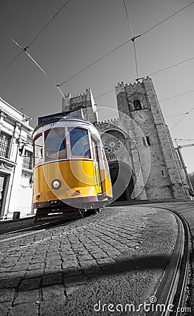 Yellow tram on the background of Lisbon Cathedral Editorial Stock Photo