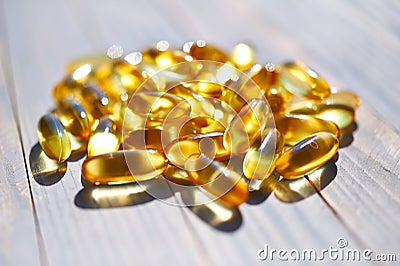 Yellow translucent pills with the fish oil Stock Photo