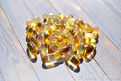 Yellow translucent pills with the fish oil Stock Photo
