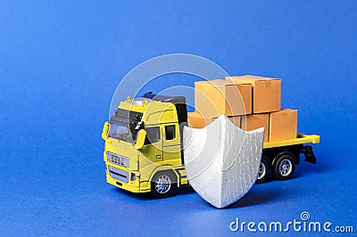 Yellow truck with cardboard boxes covered by the shield. Cargo insurance, transportation safety. Guaranteed quality and speed Stock Photo