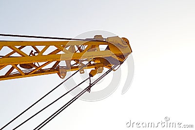 Yellow truck crane on the street. Slings in the frame. Close-up. Daylight. There is a tint Stock Photo