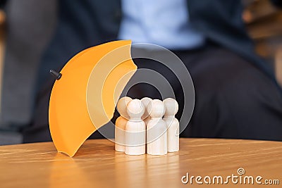 Yellow umbrella cover man wooden from crowd of employees. People, Business, Human resource management, Life Insurance and Teamwork Stock Photo